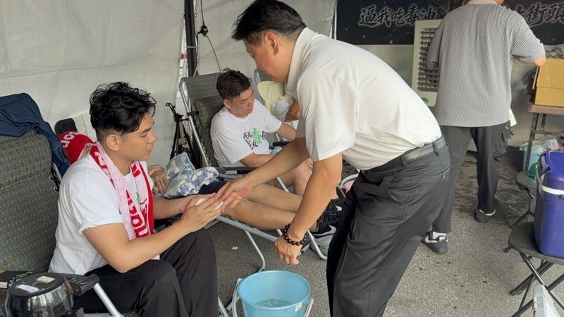 國民黨立法院黨團總召傅崐萁（蹲姿者）今天前往凱達格蘭大道探視絕食抗爭的4位年輕夥伴。記者翁至成／攝影