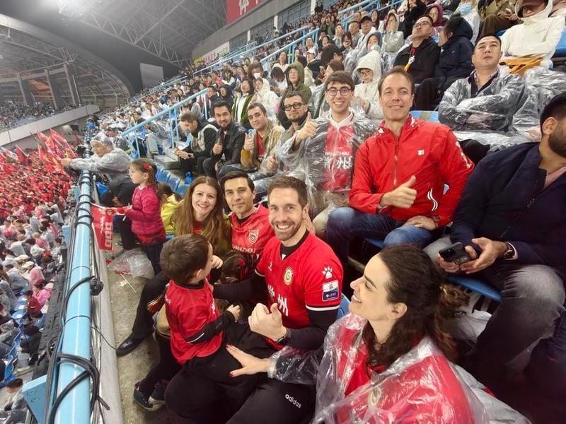 Carlos Lorite watches the opening match of Su Super League with his family and friends, April 11, 2026. Xinhua