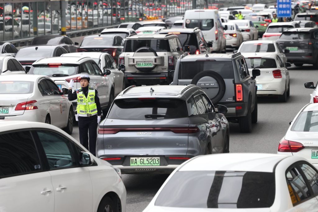 10月1日,交警在西安北站落客平台疏导送站车流。新华社发(张鑫 摄)