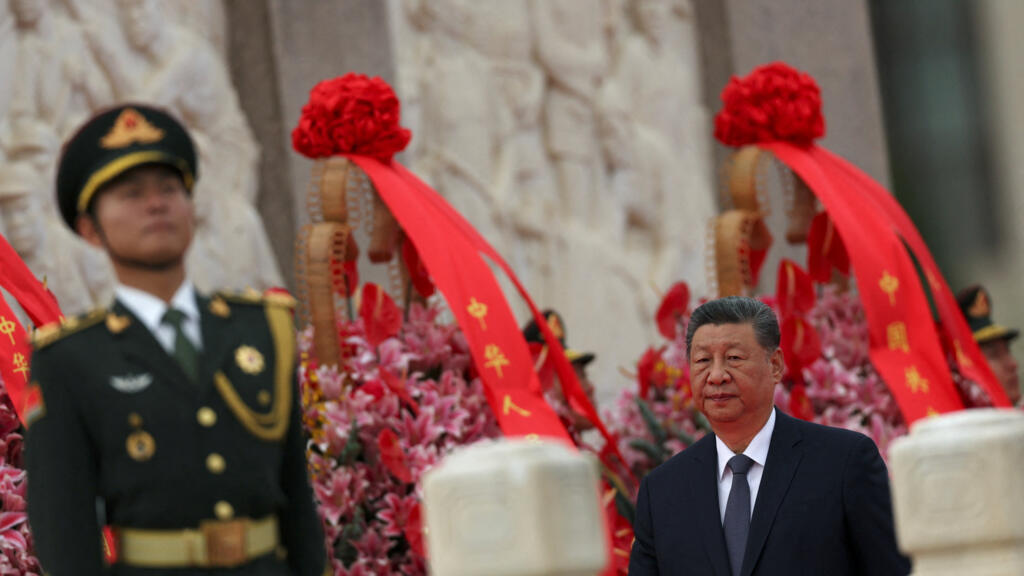 Chinese President Xi Jinping walks past floral baskets at the Monument to the People's Heroes during a ceremony to mark Martyrs' Day, a day ahead of the Chinese National Day, on Tiananmen Square in Be