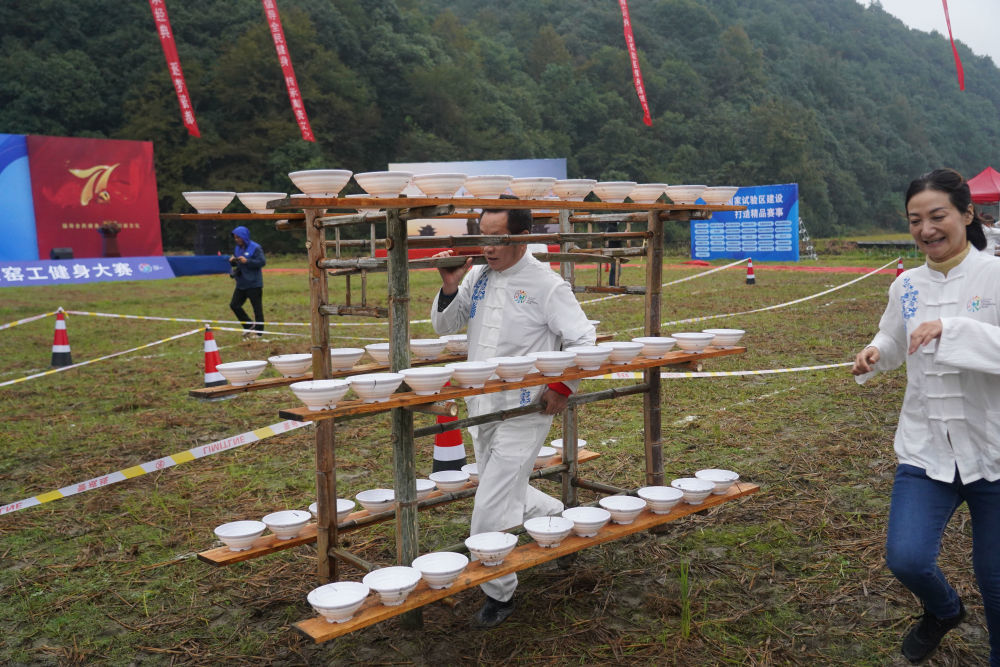 2020年10月19日,在景德镇市浮梁县湘湖镇进坑村,参赛选手在窑工健身大赛中参与驮坯挑坯比赛。新华社记者 周密 摄