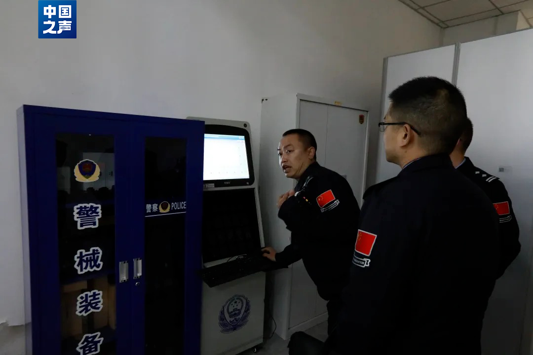 △吉隆出入境边防检查站执勤二队副队长黄棚(左一)给民警讲解查验设备。