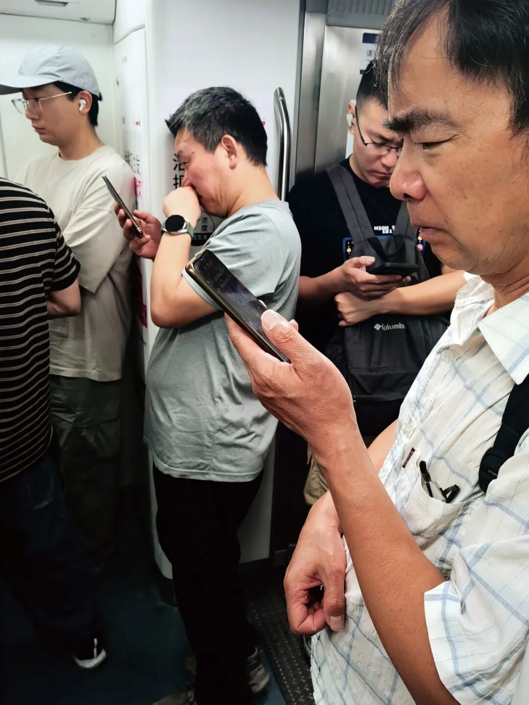 2024 年 6月5日,北京地铁10 号线,满车厢的乘客都在低头玩手机,其中不少人正在看短剧。(图 /IC)
