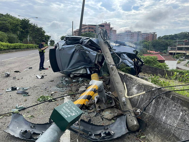 肇事車輛撞斷燈桿卡在外側護欄邊，車身嚴重變形。圖／民眾提供