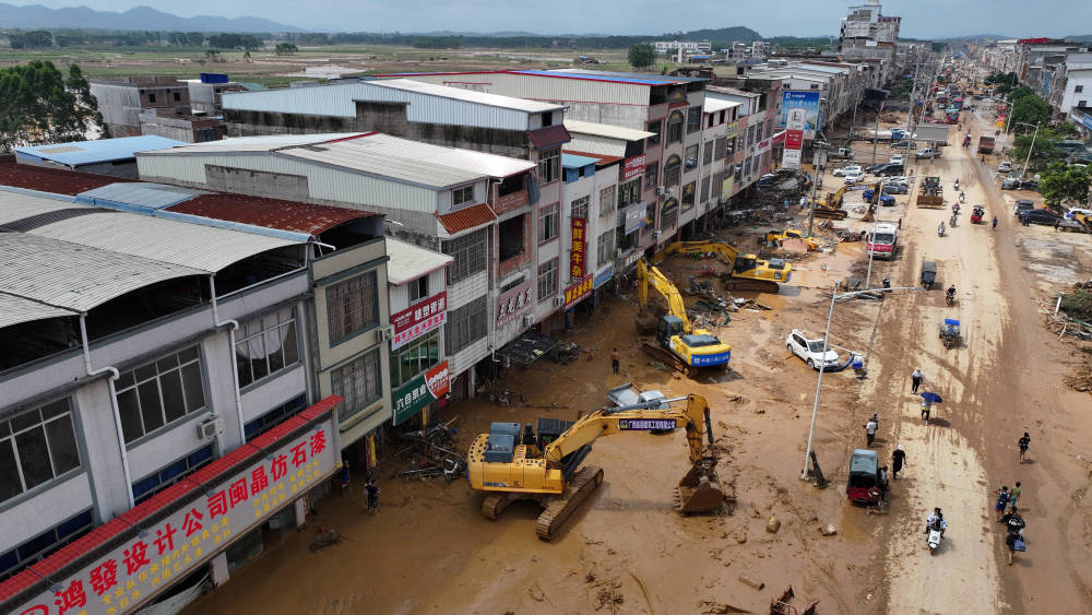 ↑ 7月9日,在广西南宁横州市云表镇,人们在清理洪水消退后的街道(无人机照片)。新华社记者 黄孝邦 摄